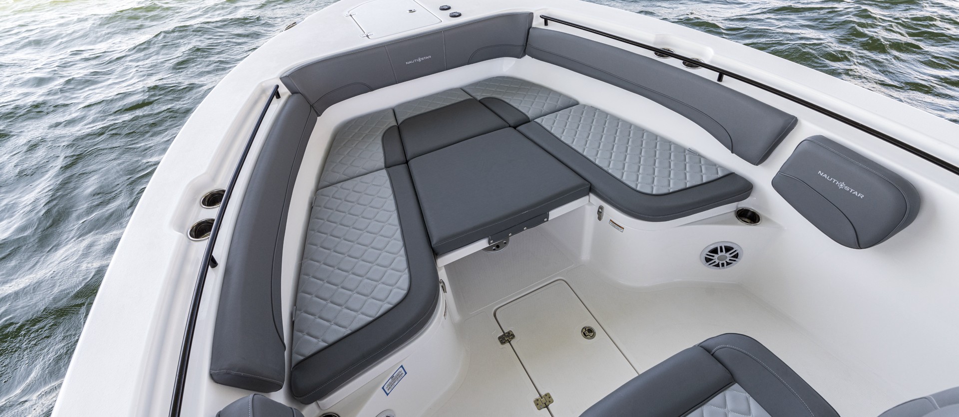 Bow seating with cushions, bolsters, and retractable table quickly transforms into a large casting deck.