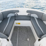 Bow chaise seating with bolsters and under deck storage