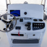 Fiberglass helm dash with Simrad NSX9 (9" screen) and stainless steel wheel with power knob