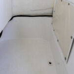 Large console storage and portable toilet (not shown)