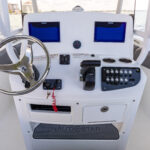 Helm dash with optional dual screens, stainless steel wheel with power knob, and footrest with anti-fatigue mat